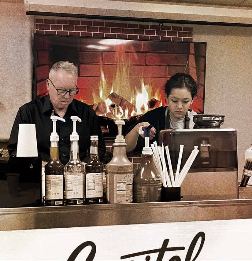 Two Capitol Coffee baristas serving at a holiday party