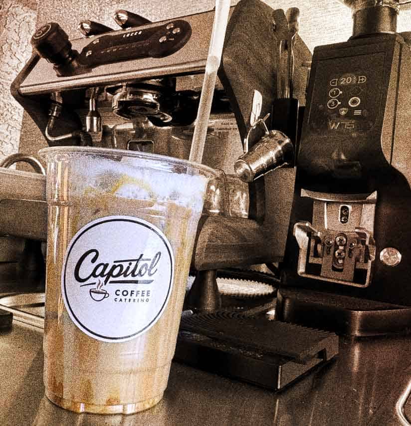 Iced latte in a Capitol Coffee branded cup