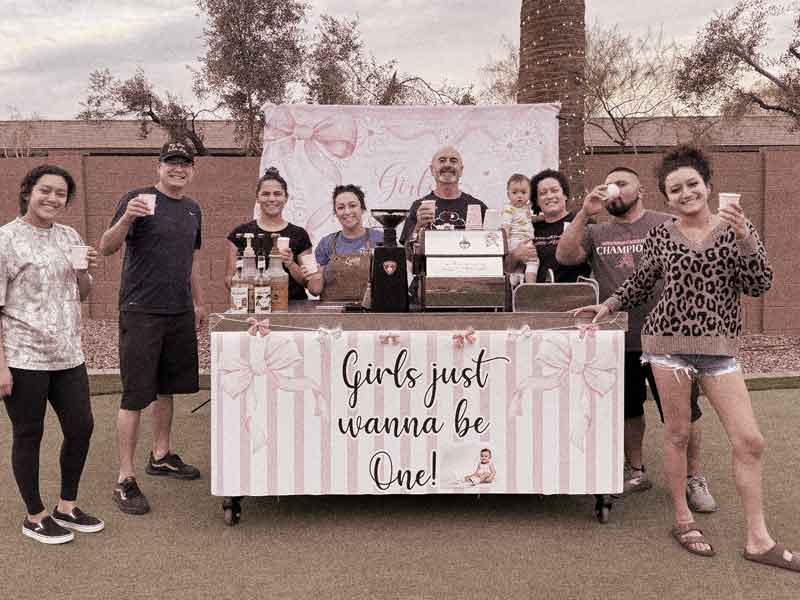 Guests gathered around a decorated Capitol Coffee cart at a private party